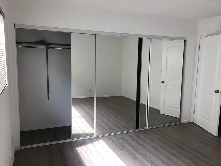 Another view of the closet, partial view of the door to the bedroom.