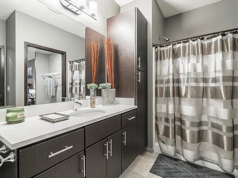 Our bathrooms feature modern hardware, quartz countertops and ample storage.