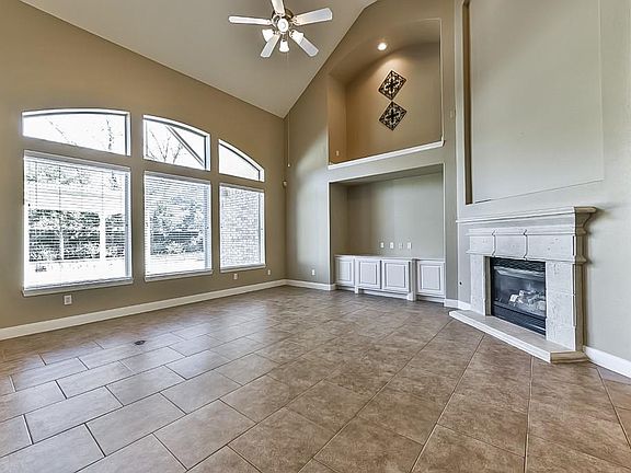 Living Room has Lots of Light & a View of the Covered Patio &  Stately Arbor in the Back Yard.