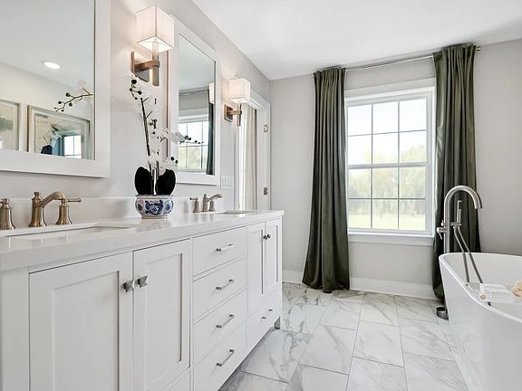 Primary bath with freestanding vanity and soaker tub