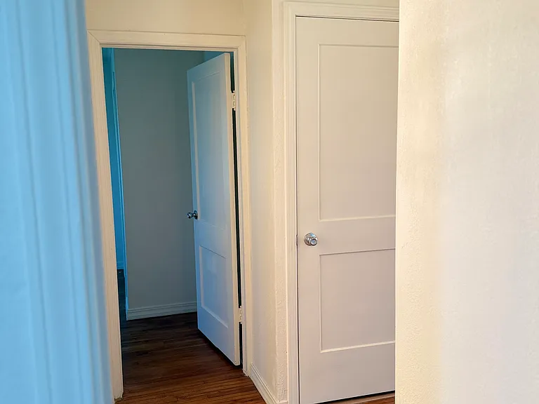 hallway looking at bedroom 2 and door to laundry area