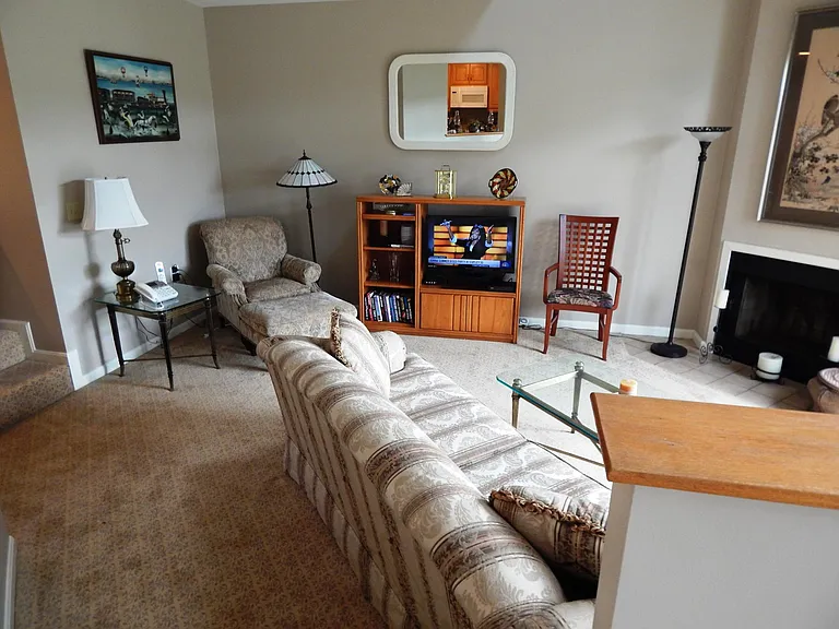 view living room from 2-step elevated dining room. Flat-screen TV with DVR & voice control Verizon More FIOS 2.0 television service