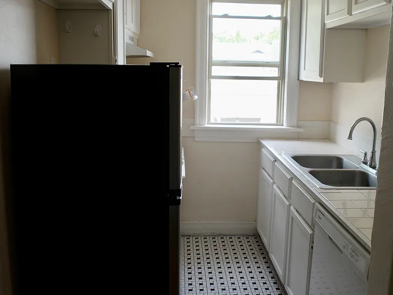 Galley kitchen, fridge, electric oven, dishwasher.