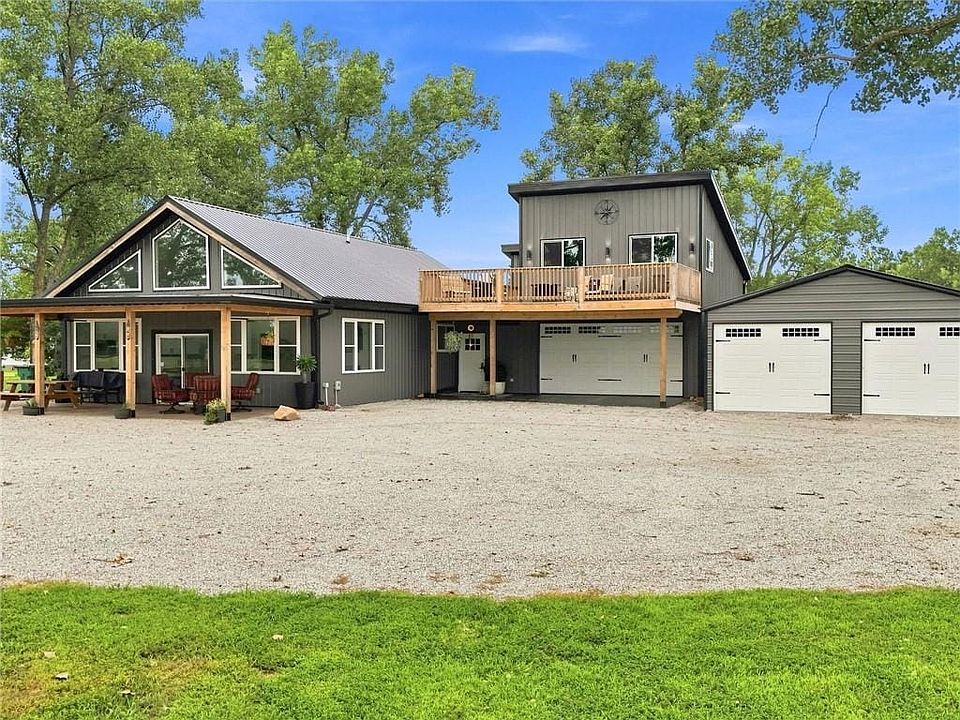 Modern farmhouse exterior with a metal roof and a covered porch