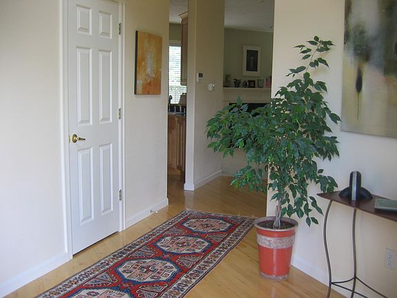 View when walking into the home from the front door. Door to the left is a powder room. Next opening is kitchen.