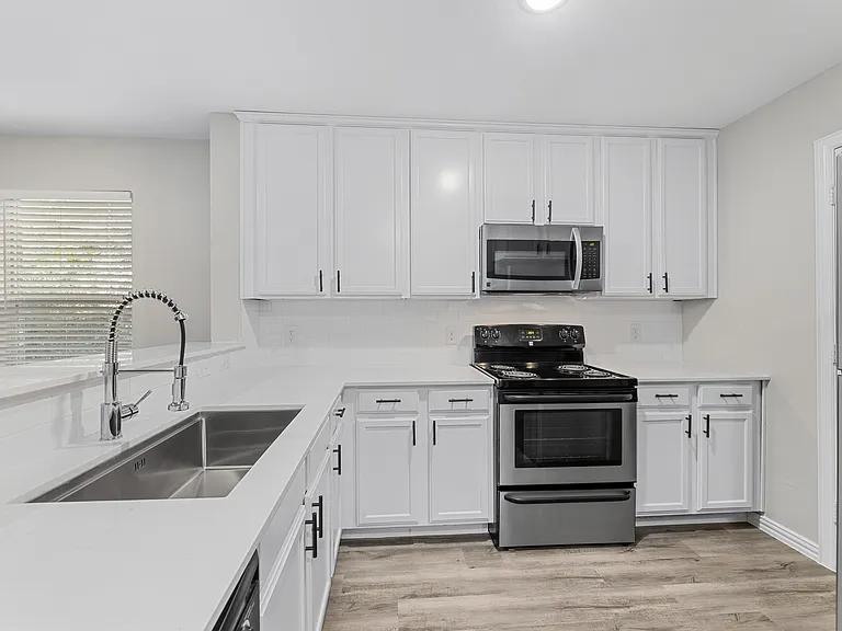 Kitchen with Stainless Steel Appliances - Renovated Home