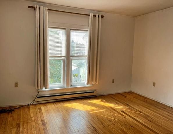 Natural light with refinished hardwood floors in living room