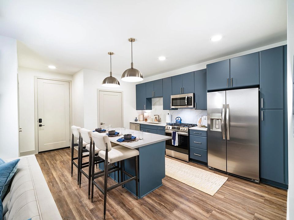 A spacious kitchen with a central island, full-size appliances, and streamlined cabinetry offers an additional finish option, designed to support your individualized daily routine.