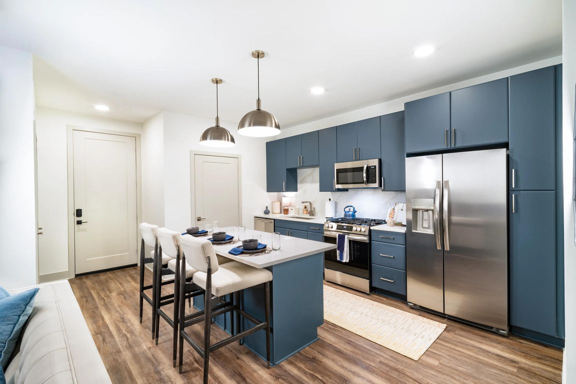 A spacious kitchen with a central island, full-size appliances, and streamlined cabinetry offers an additional finish option, designed to support your individualized daily routine.