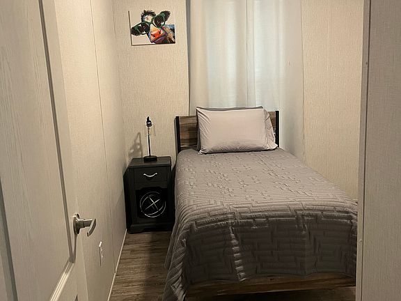 3rd bedroom, twin size bed with dresser and tv.