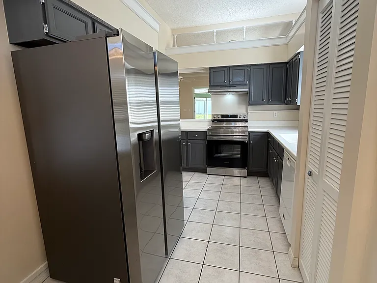 Kitchen with brand new refrigerator and range