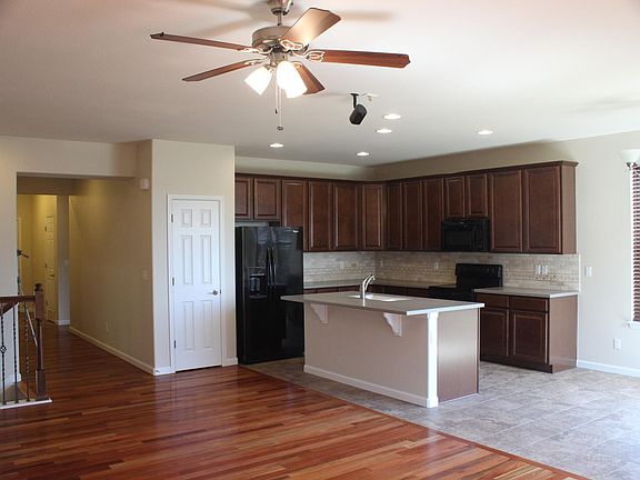 Kitchen from Living Room, Stairs Down, Hall to Laundry + Garage, 2 Bedrooms + Bath, Font Door