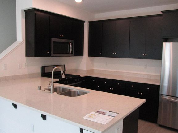 Kitchen showing new 3-door refrigerator installed.