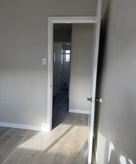 Leaving Front Bedroom to Hallway with Bathroom Window Shining in the Background