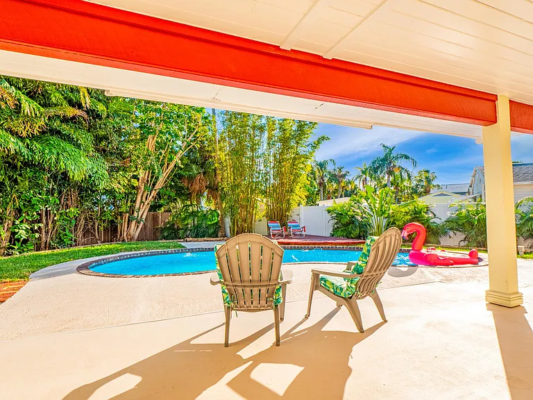 huge covered lanai overlooking the pool with 2 ceiling fans to keep you cool.