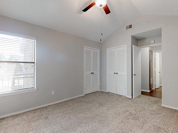Bedroom with vaulted ceiling in upstair units.