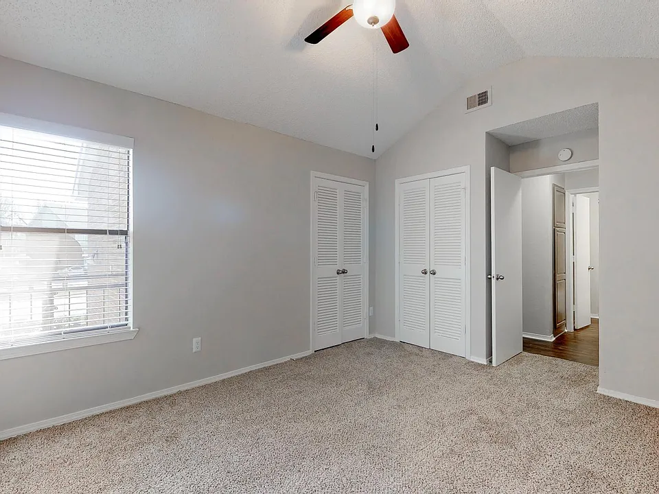 Bedroom with vaulted ceiling in upstair units.