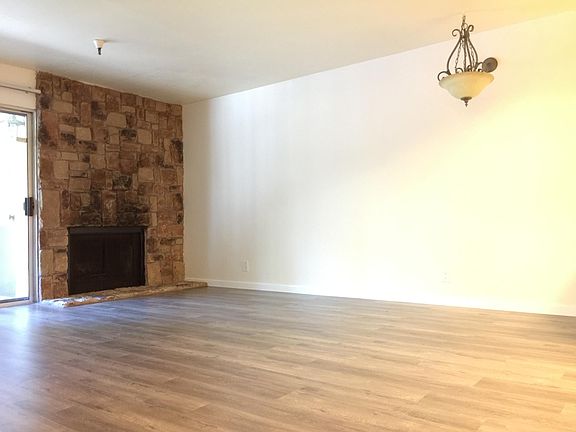 Living room features fireplace with brand new hardwood floor