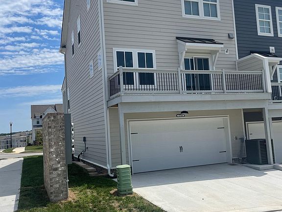 Rear of townhouse with 2 car garage and storage space