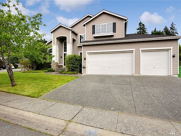 Front of the house with large 3 car garage and driveway