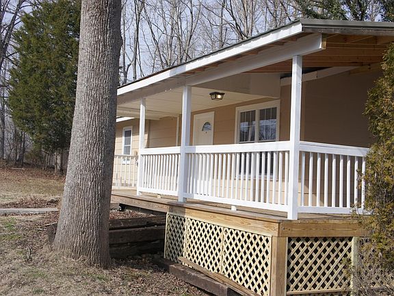 Beautiful covered deck wraps around to a side balcony with a