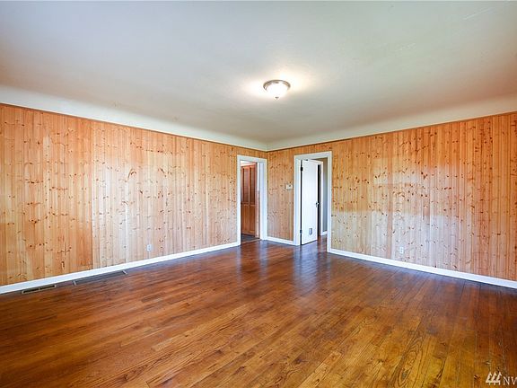 Living Room has pine paneled walls and fir wood floors