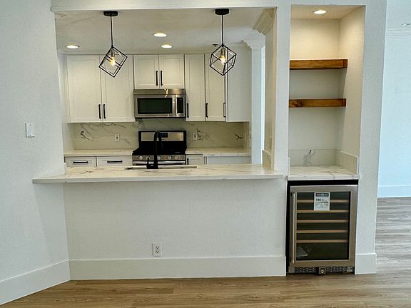 Open floor plan with breakfast bar and new mini fridge.