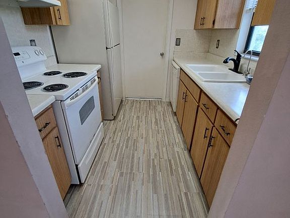 Ktichen goes out to garage / laundry. Includes disposal and dishwasher