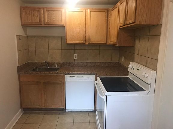 Full kitchen with dishwasher and electric stove. Picture shows old dishwasher; replaced in 2020.