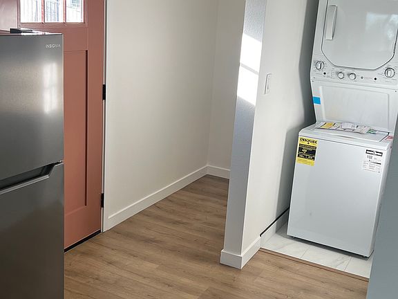 Washer/dryer in unit with additional storage space.