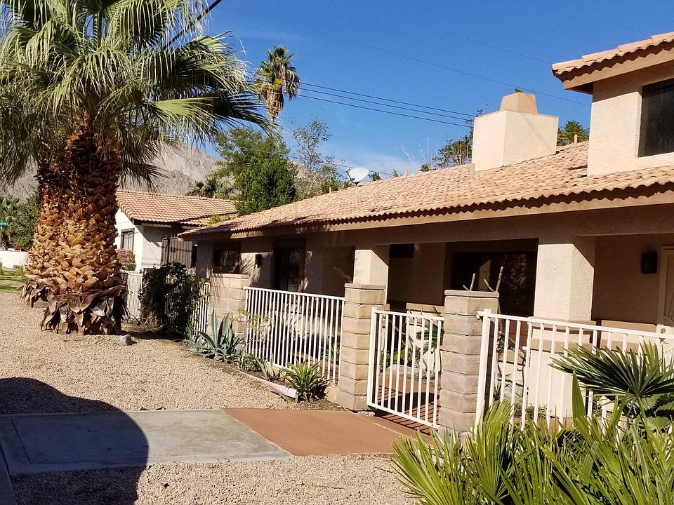 Front Gate entrance area with great Palms and bushes.