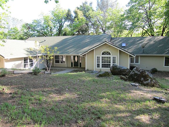 Front of home with great rock outcroppings