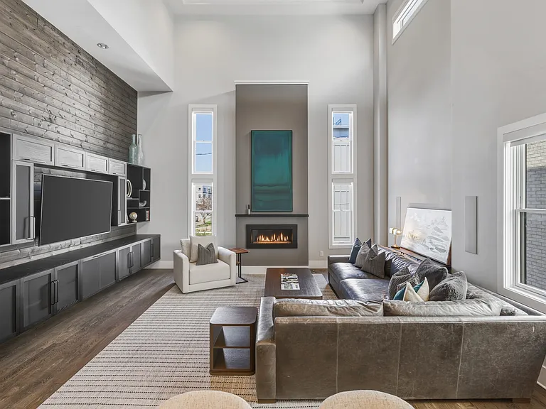Bright, modern living room with HUGE ceilings. Abundant natural light, plush seating for everyone, a cozy gas fireplace, and a Smart TV_perfect for relaxing.