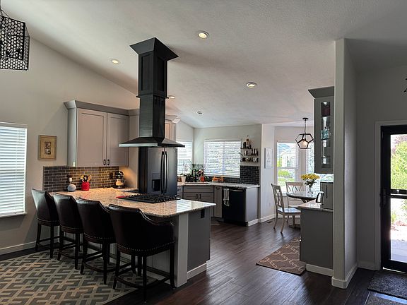All-new open-concept kitchen with vaulted ceilings, a gas range and Pikes Peak Views.