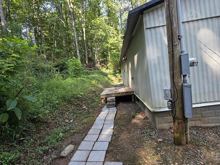 Rear of home with small deck.
