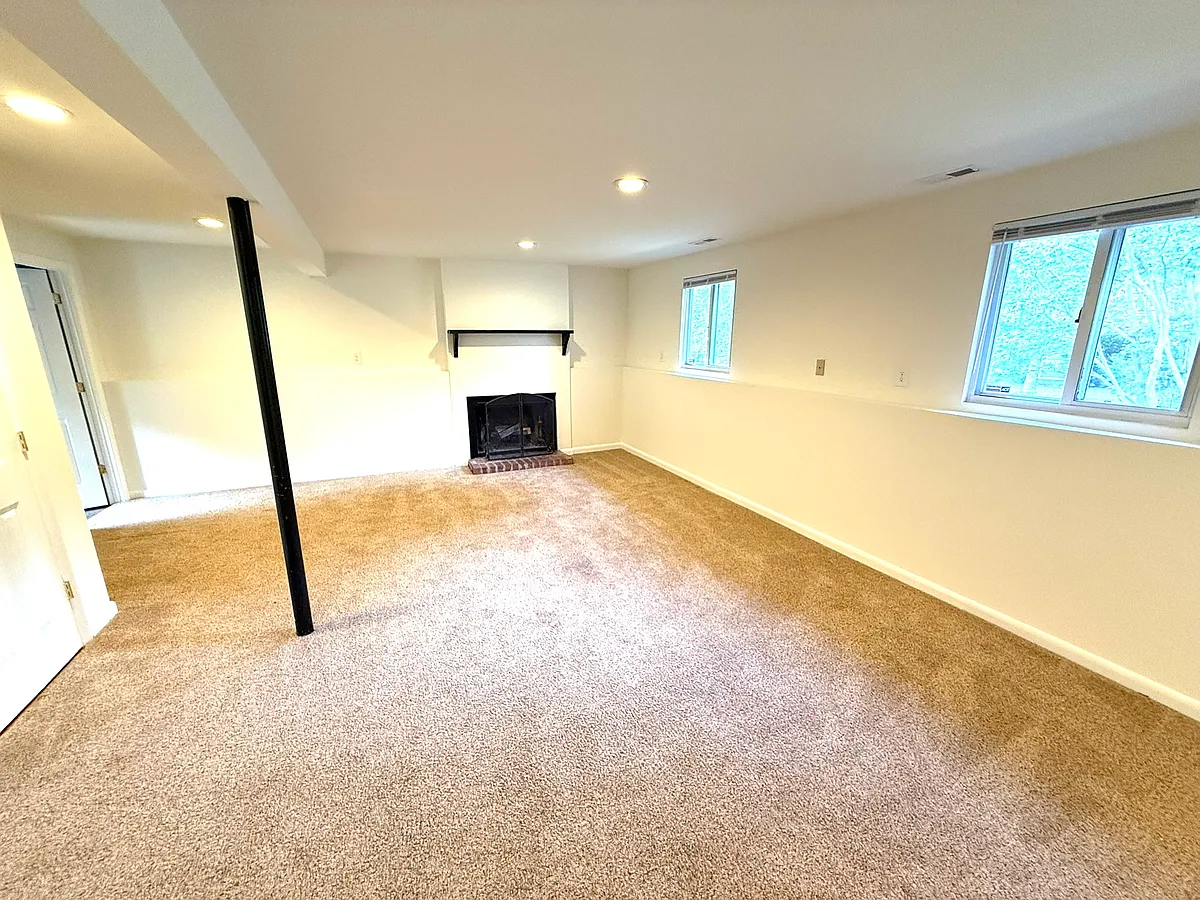 Large den with fireplace and brand new, luxurious carpet. - 5306 Autumnleaf Dr