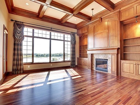 Living room with Brazilian cherry floors, gas fireplace, 14' coffered ceiling and beautiful view!