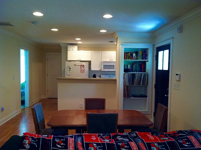 View of kitchen and bookshelf from living room