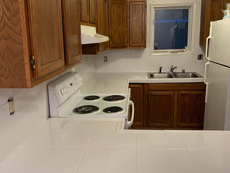 Kitchen with microwave, dishwasher, oven, and fridge