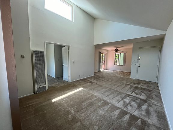 Next to window. Bedroom entrance, Dining area, Front door - left to right.