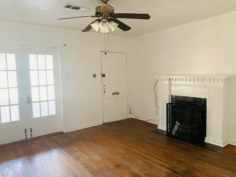 Living Room view - faux fireplace, French doors leading to screened front patio.