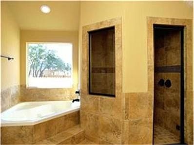 King & Queen Master Bath with a large walk-in steam shower featu