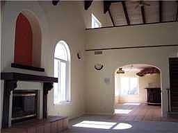 Living room w/fireplace leading into entertainment area w/full bar.