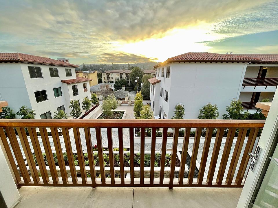 Private patio looking out to courtyard and hills during sunset