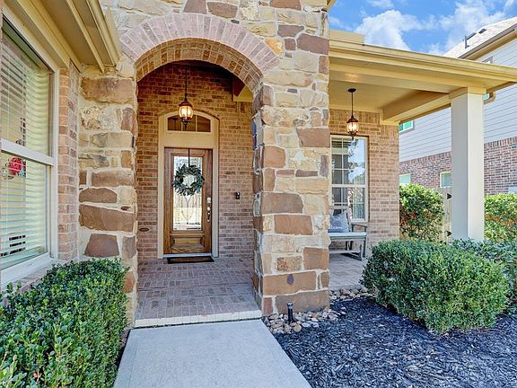 The welcoming front door contains leaded glass and this home has a ring doorbell for safety and Smart home features. This front door lock can be used with voice and iPhones.