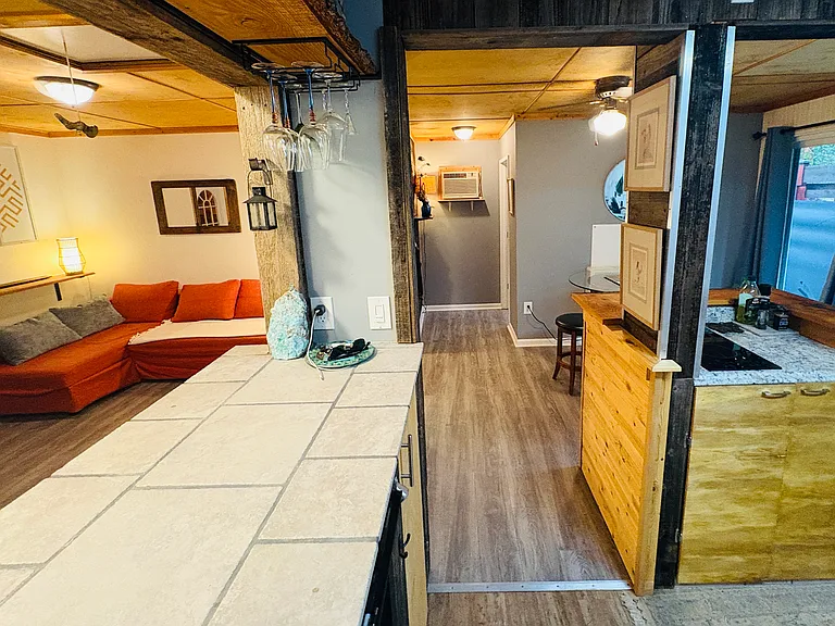 Looking from kitchen through bar top into open living and dining area.