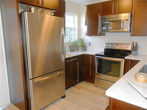 The kitchen is over the top with custom cabinets, flooring, countertops and stainless appliances.
