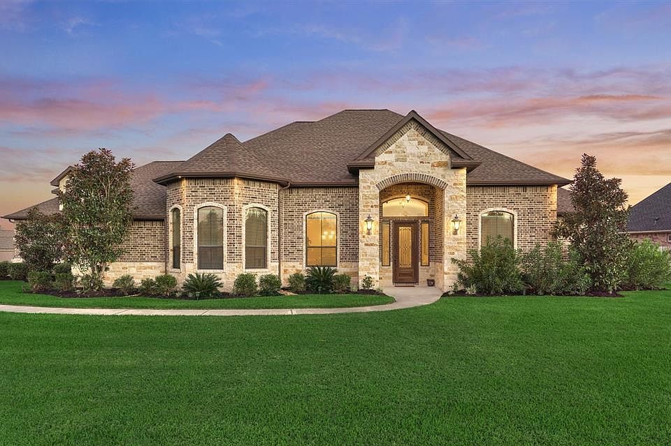 Instant curb appeal upon arriving with the landscaping, paved walkway and gorgeous brick and stone exterior