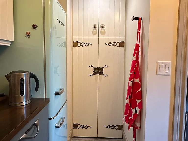 Rolling pantry shelves behind doors, above with microwave.