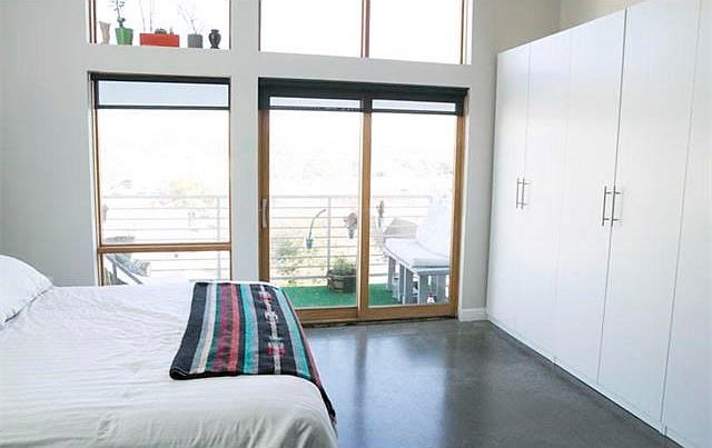 Gorgeous bedroom area with tons of light and good storage.